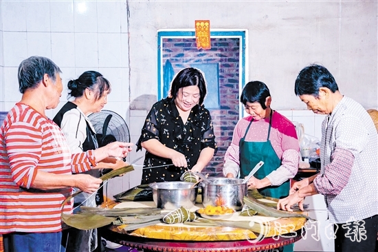 非遺傳承人呂艷卿正在傳授柴火粽的制作技藝。