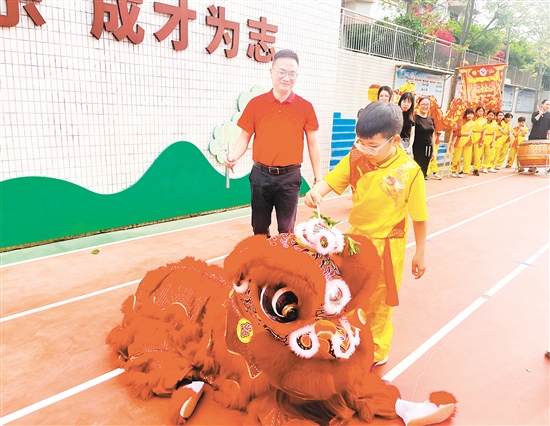 址山小學相關負責人和學生代表手持毛筆，飽蘸朱砂，為醒獅點睛。